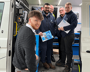 PCL's Kian Jones stood outside the PCL Demo Van with the Thomas Graham team